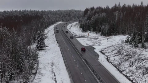 Forward aerial drone view of snowy motorway near Armsjön, Sweden Видео 333673940