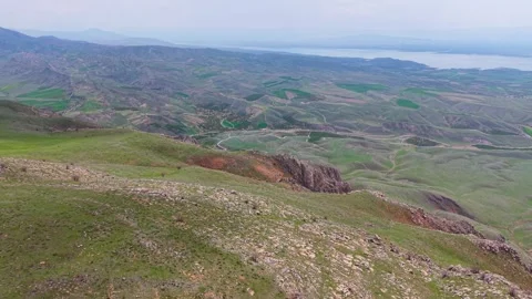 Forward Aerial Flight Along Rocky Mountain Slopes Toward a Distant River 스톡 동영상 340916583
