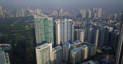 Forward aerial flight, tilt down, urban view approaching high rise buildings. Stock-Footage 130157525