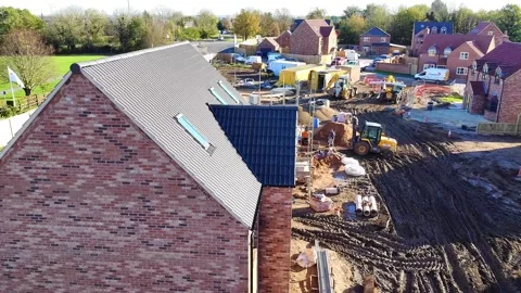 Forward aerial view down a muddy building site Stock Footage 339592559
