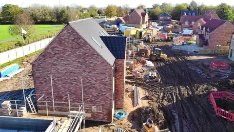 Forward aerial view down a muddy house building site. Stock Footage 340535984