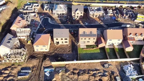 Forward aerial view over a new housing estate under construction Video stock 342949897
