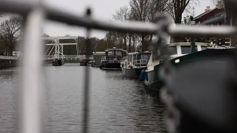 Forward approach toward bridge over calm canal waters Stock Footage 331839295
