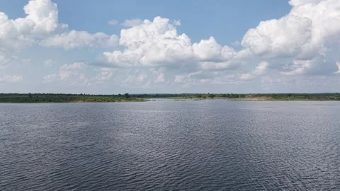 Forward-ascending-drone-over-lake-under-dramatic-clouds Stock Footage 341591228