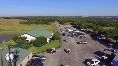 Forward Ascending Drone Shot of Golf Cart Caravan into the Woods Video stock 76011000