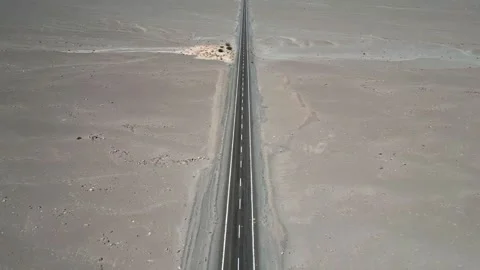 Forward ascending reveal along endless straight paved highway cutting through Stock Footage 336266003