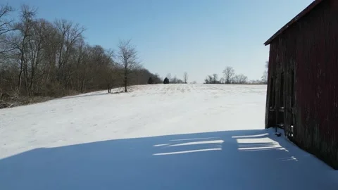 Forward between country barn and farm field winter 4K Stock-Footage 169819260