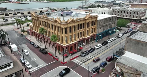 Forward descending flight viewing an old building on a street corner Stock Footage 250582503