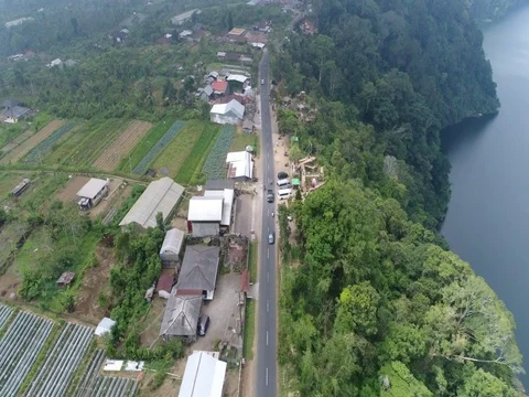 Forward descent over small town road near a lake in Bali Indonesia. Stock Footage 80148833