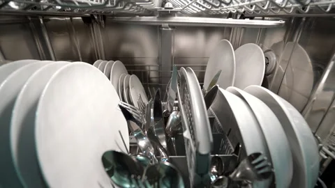 Forward dolly shot of dishwasher machine with dishes and silverware Stock Footage 147073991