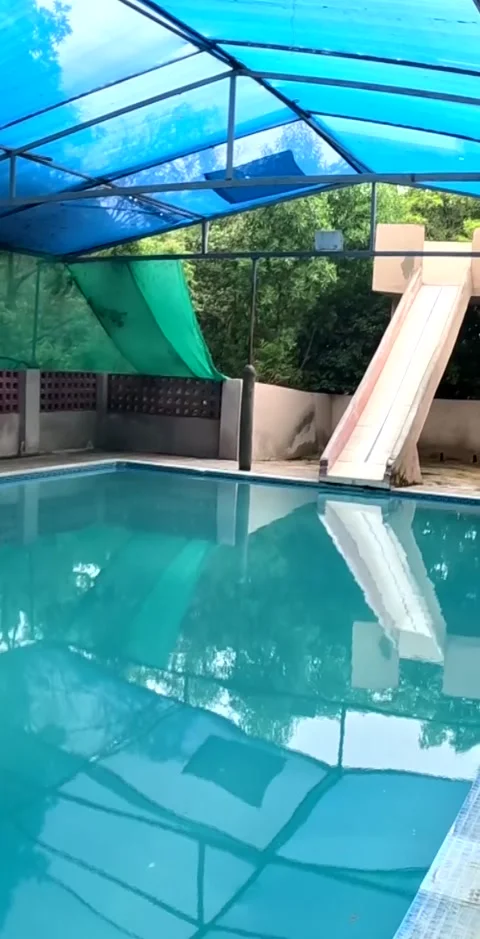 Forward Dolly Shot of Empty Swimming Pool with Water Slide Stock Footage 341033799