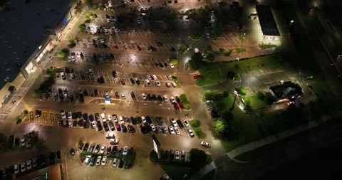 Forward downward looking flight viewing cars in a parking lot Stock-Footage 335669889