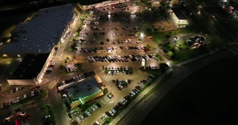 Forward downward looking flight viewing cars in a parking lot Stock-Footage 335669928