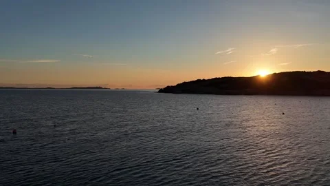 Forward Drone Flight Along Beach as Sun Slowly Rises Behind Hill Vídeo Stock 334854665