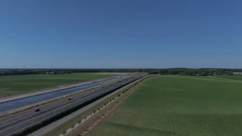 Forward drone flight over highway and canal in rural landscape Stock Footage 343839739