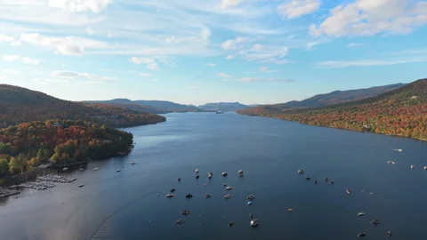 Forward Drone Flight Over Mountain Lake With Boats in Autumn Stock Footage 321378176