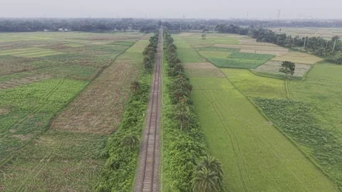 Forward Drone Flight Over Railway Track Through Open Fields in Bangladesh Stock Footage 337059900