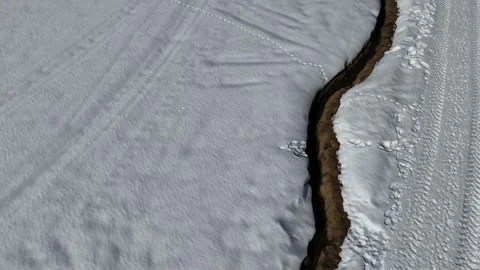 Forward Drone Flight Over Snowy Path with Close Ground View in the Itali Stock Footage 332234941