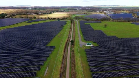 Forward drone flight over vast utility scale solar panel arrays generating Stock Footage 342080880