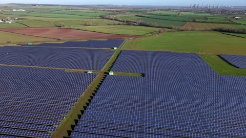 Forward drone flight over vast solar panel arrays capturing warm golden hour Stock Footage 342081239