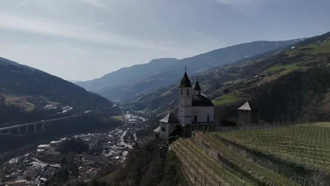 Forward Drone Flight Over Vineyards Toward Church Dome in Chiusa, South Stock Footage 335579541