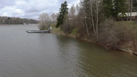 Forward drone flight past riverside pier Video stock 329742292