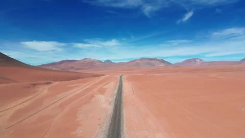 Forward drone flight skimming low over a straight desert highway cutting Stock Footage 334651940