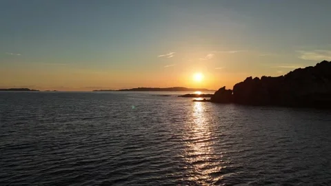 Forward Drone Flight Into Sunrise Behind Hill Over Mediterranean Beach Vídeo Stock 334946055