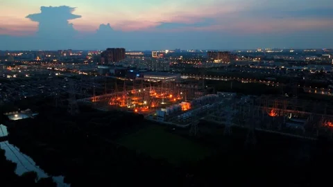 Forward Drone Flight Toward Illuminated Power Substation at Dusk Stock Footage 342145294