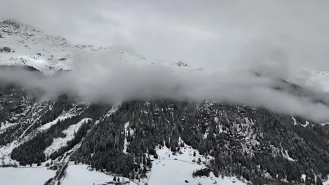 Forward Drone Flight Toward Snow-Covered Mountain with Forest and Clouds Vídeo Stock 336545601