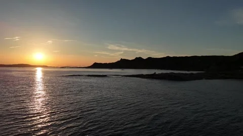 Forward Drone Flight Toward Sunrise Over Hills and Sea in Sardegna Stock Footage 332940573