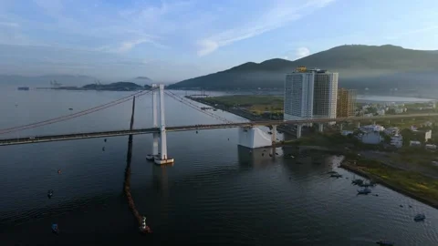 Forward drone flight toward Thuan Phuoc Bridge at sunrise in Da Nang Stock Footage 340874492