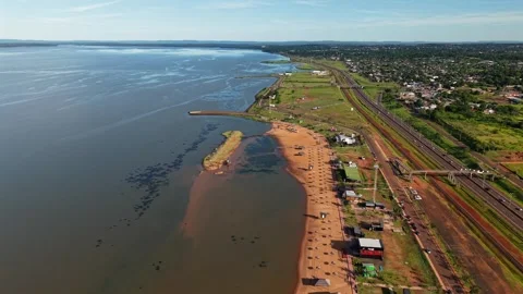 Forward drone fly over sandy coastal Balneario Costa Sur with Paraná River on Vídeos de archivo 321669701