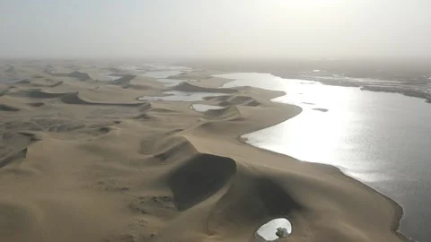 Forward Drone Over Curved Sand Dunes Beside Desert Lake Ejina China Stock Footage 330455068