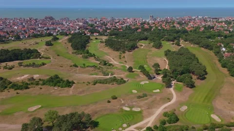 Forward Drone Over Knokke Golf Course with Sea View | FlyLens 4K Stockbeeldmateriaal 310406651