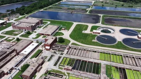 Forward drone shot above large sludge settling ponds at a water reclamation Stock Footage 339039544