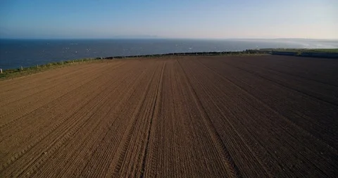 Forward Drone Shot Over A Farm Field Near Irish Sea Coast Stock Footage 125322148