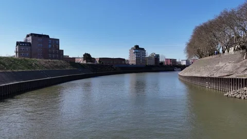 Forward drone under bridge toward canal homes Stock Footage 331896858