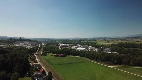 Forward flight along rail corridor toward Lyss factories Stock Footage 331897469