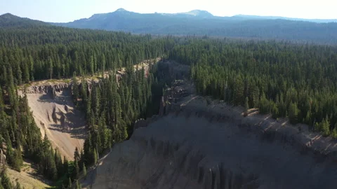Forward flight over a canyon formed by volcanic activity in Oregonian lush fo Stock Footage 143802781