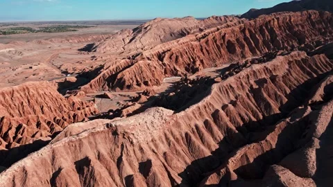 Forward flight over dramatic eroded salt rock badlands with sharp ridges and Stock Footage 336266311