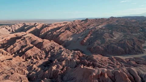 Forward flight over dramatic eroded salt rock ridges and deep ravines revealing Stock Footage 336266668