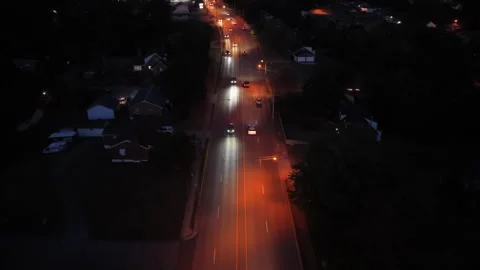 Forward flight over a lit arterial road in Lynchburg at night Stock Footage 346619450