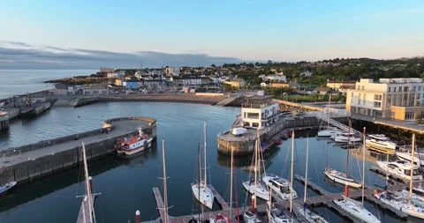 Forward flight over modern harbor channel with fishing vessel and yachts at c Stock Footage 340324014