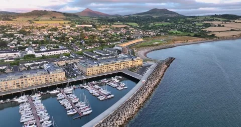 Forward flight over a quiet Irish marina, showing sailboats, toward the Sugar Stock Footage 340323825