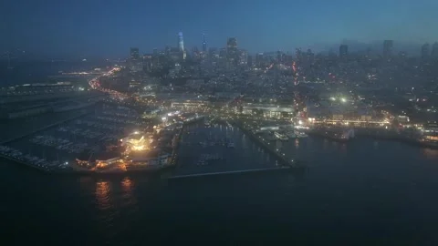 Forward flight from Pier 39 across illuminated city to Downtown San Francisco Stock Footage 254071302