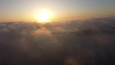 Forward flight sunrise over low clouds over water and land 스톡 동영상 175271540