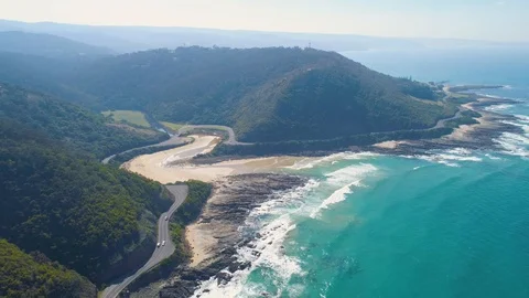 Forward flight toward cars navigating the bends on Great Ocean Road in Victor Stock Footage 107490454