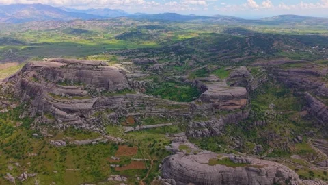 Forward Flight Toward a Massive Rock Mountain Above a Dramatic Green Valley Stock Footage 341134124