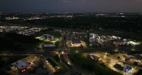 Forward flight viewing business highways and traffic as night sets in Stock Footage 335669899